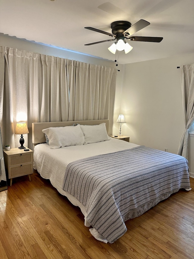 bedroom featuring hardwood / wood-style flooring and ceiling fan