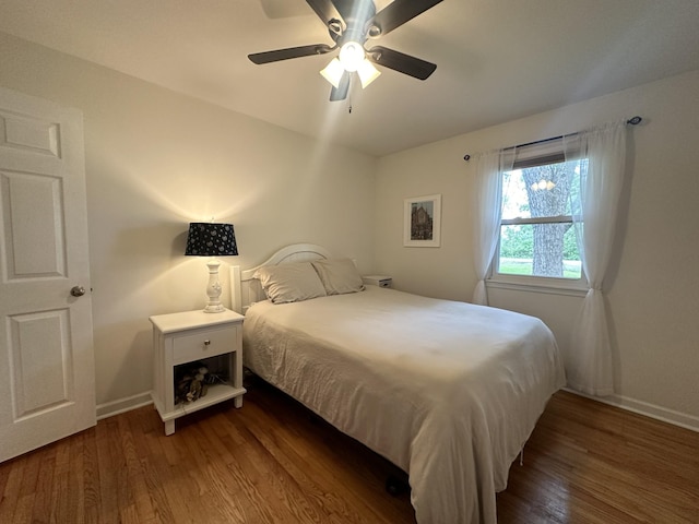 bedroom featuring ceiling fan and dark hardwood / wood-style flooring