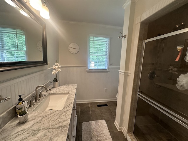 bathroom featuring an enclosed shower, vanity, toilet, and ornamental molding