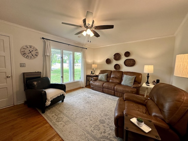 living room featuring hardwood / wood-style flooring, ceiling fan, and crown molding