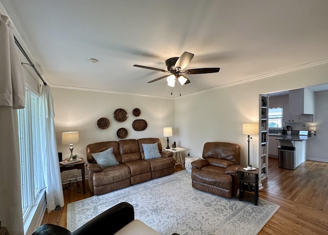 living room featuring ceiling fan, hardwood / wood-style floors, and ornamental molding