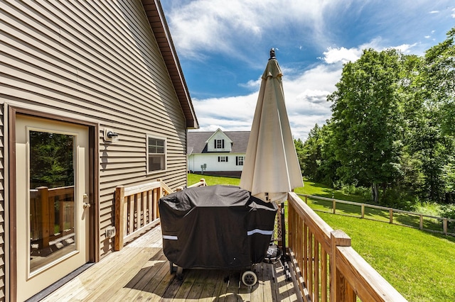 wooden deck with a yard, area for grilling, and fence