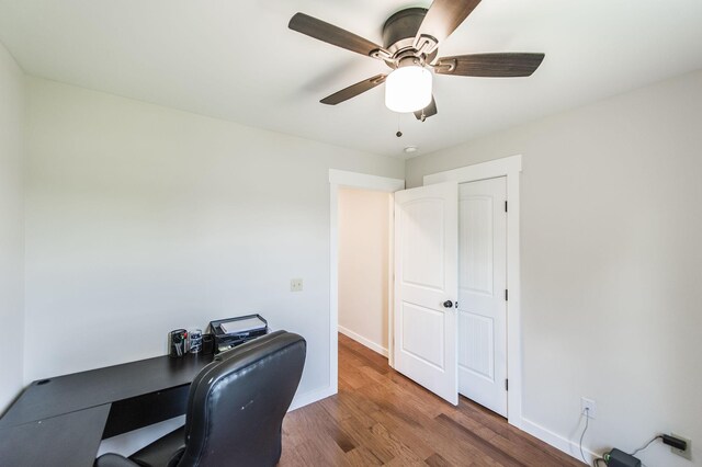 office space with ceiling fan, baseboards, and wood finished floors