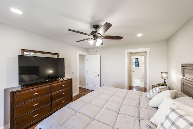 bedroom with baseboards, wood finished floors, a ceiling fan, and recessed lighting