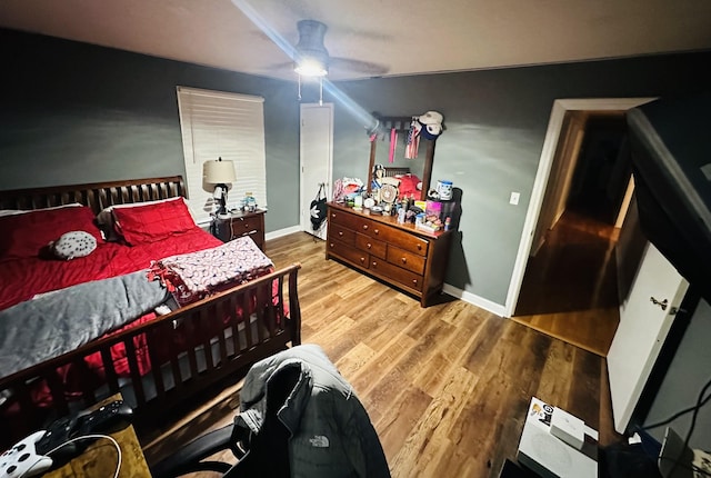 bedroom with ceiling fan and wood-type flooring