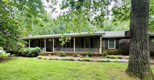 ranch-style home featuring a porch and a front yard