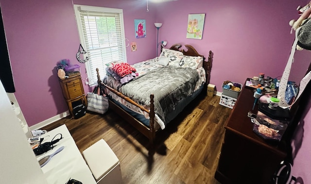 bedroom with dark hardwood / wood-style floors