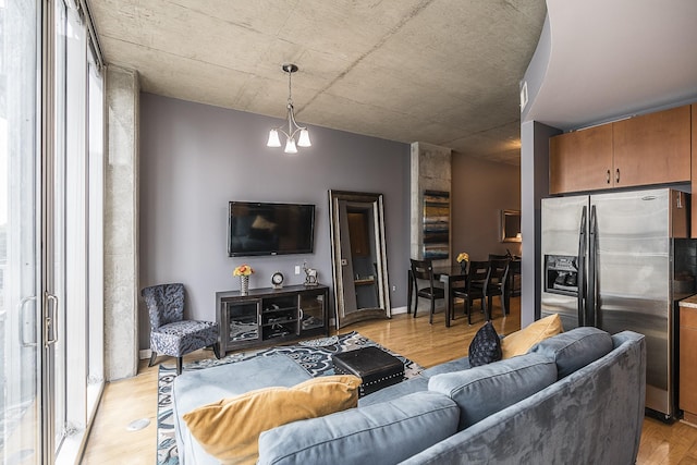 living room featuring light wood-type flooring and a chandelier