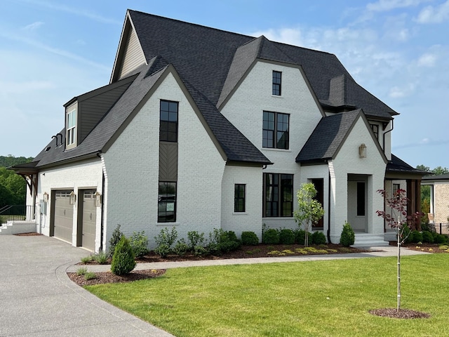 view of front of home featuring a front yard and a garage