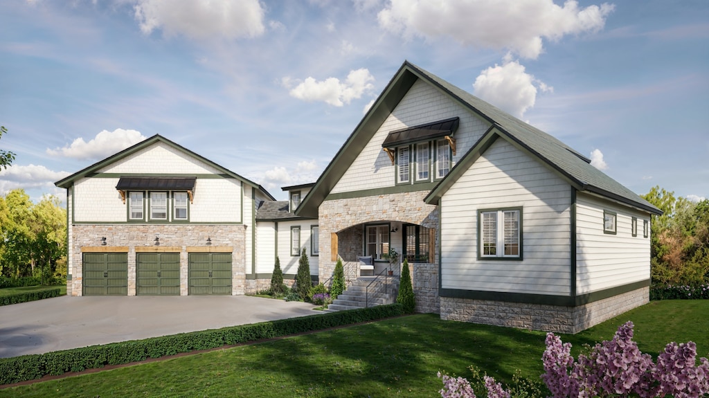 view of front of property with a front yard and a garage