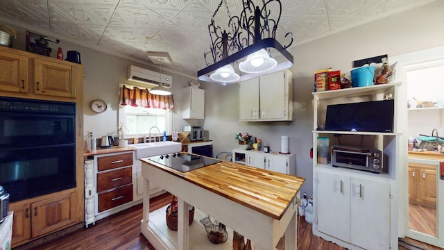 kitchen featuring sink, dark hardwood / wood-style flooring, butcher block countertops, a wall mounted AC, and black appliances