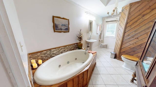 bathroom featuring sink, a washtub, tile patterned flooring, a chandelier, and toilet