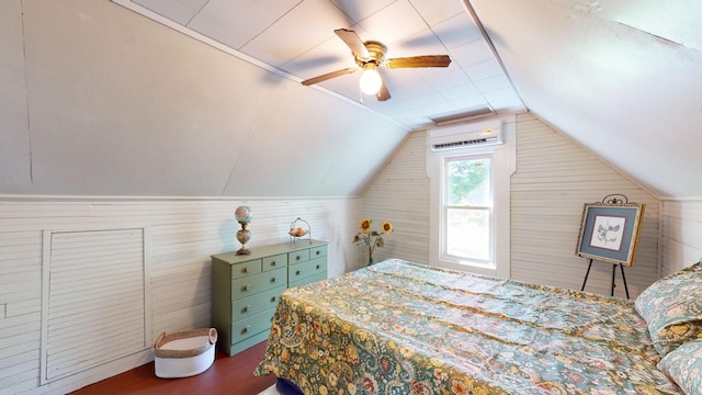 bedroom featuring ceiling fan, wood-type flooring, an AC wall unit, and lofted ceiling