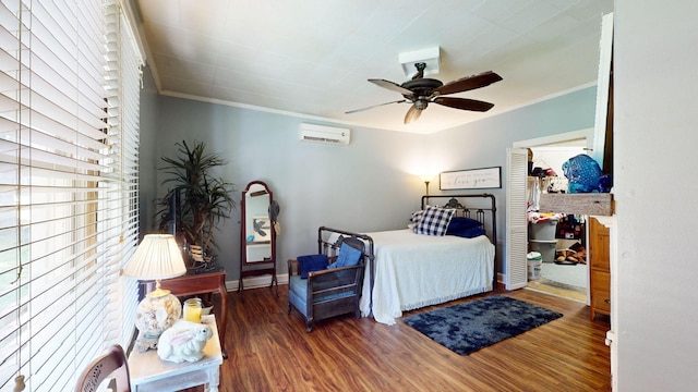 bedroom featuring a wall mounted air conditioner, ceiling fan, ornamental molding, and dark wood-type flooring