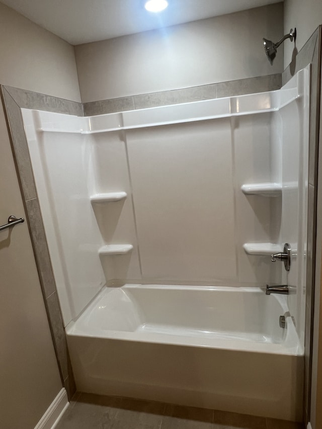 bathroom with tile patterned flooring and  shower combination