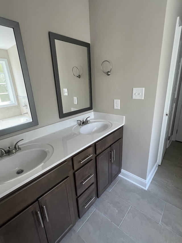 bathroom featuring vanity, tile patterned floors, and a bathing tub