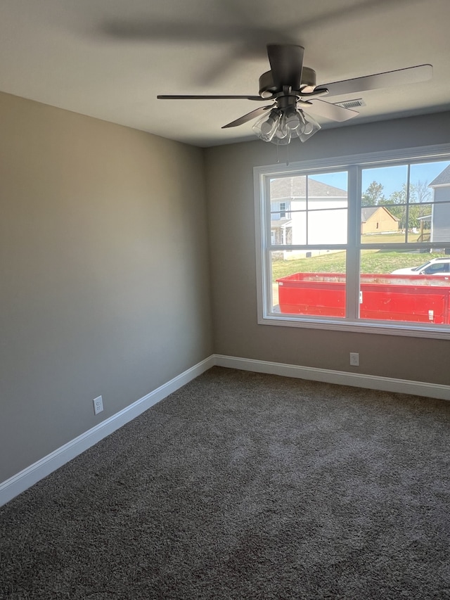 carpeted empty room featuring ceiling fan