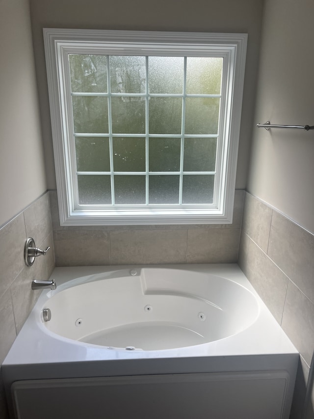 bathroom with plenty of natural light and a tub to relax in