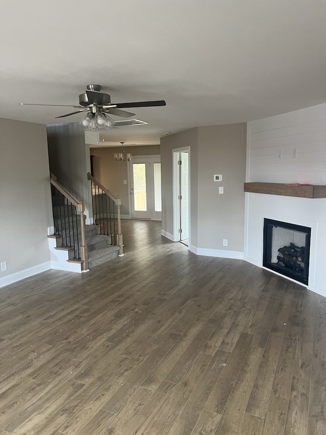 unfurnished living room featuring ceiling fan and hardwood / wood-style floors