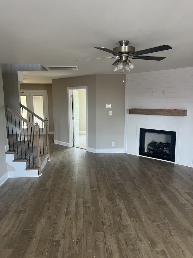 unfurnished living room with ceiling fan and dark hardwood / wood-style floors