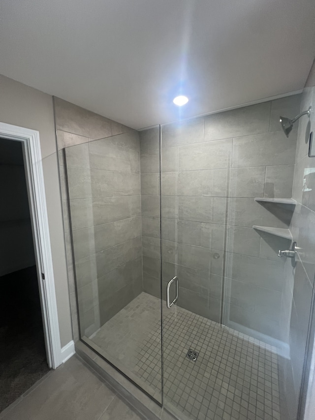 bathroom featuring a shower with shower door