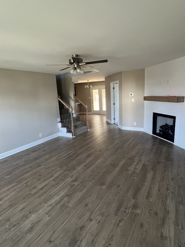 unfurnished living room with ceiling fan and dark wood-type flooring