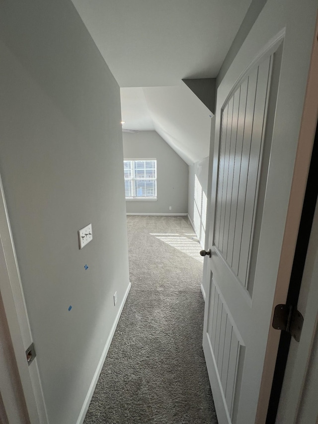 interior space with carpet floors and vaulted ceiling