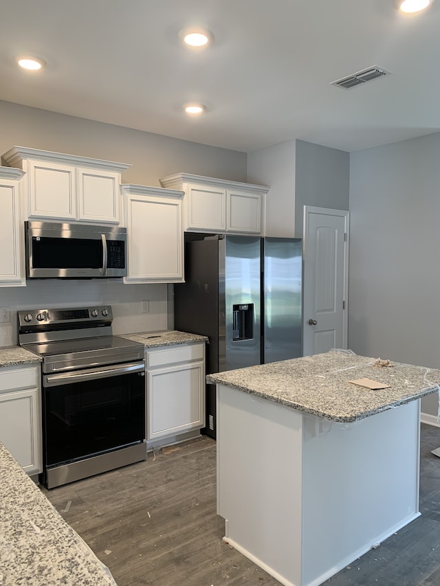 kitchen featuring white cabinetry, dark hardwood / wood-style flooring, and appliances with stainless steel finishes