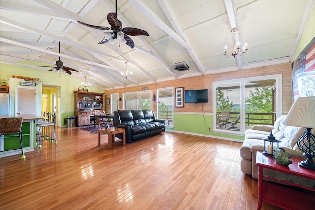 living room featuring lofted ceiling with beams, wood-type flooring, and ceiling fan with notable chandelier