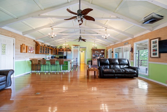 living room with vaulted ceiling with beams, light hardwood / wood-style flooring, and an inviting chandelier