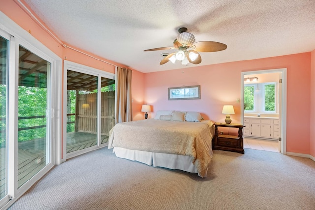 carpeted bedroom with access to exterior, ceiling fan, ensuite bath, and multiple windows