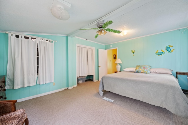 carpeted bedroom with ceiling fan, lofted ceiling, and ornamental molding