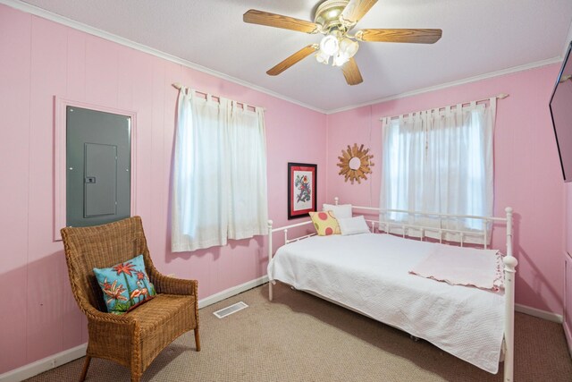 bedroom with carpet flooring, electric panel, ceiling fan, and crown molding