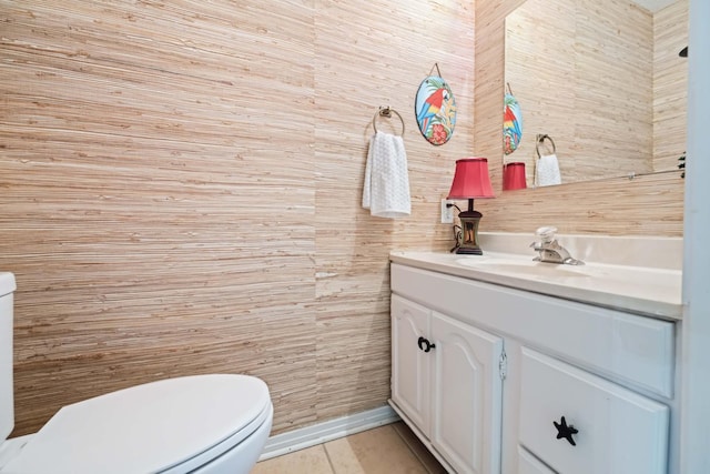 bathroom with tile patterned flooring, vanity, and toilet