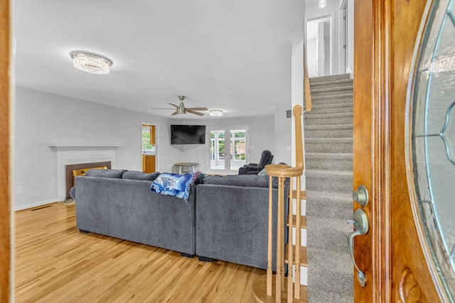 living room featuring hardwood / wood-style flooring and ceiling fan