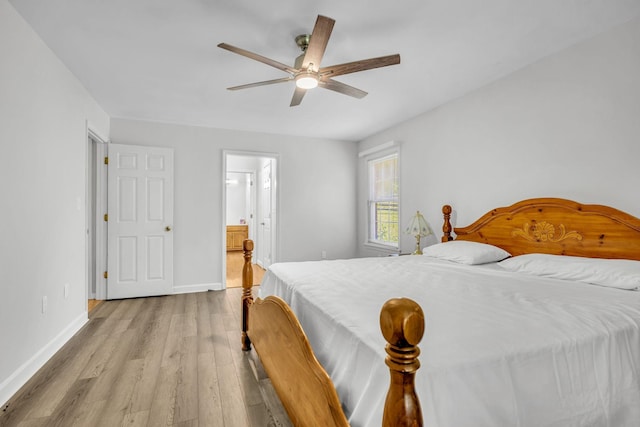 bedroom featuring light hardwood / wood-style floors, ensuite bath, and ceiling fan