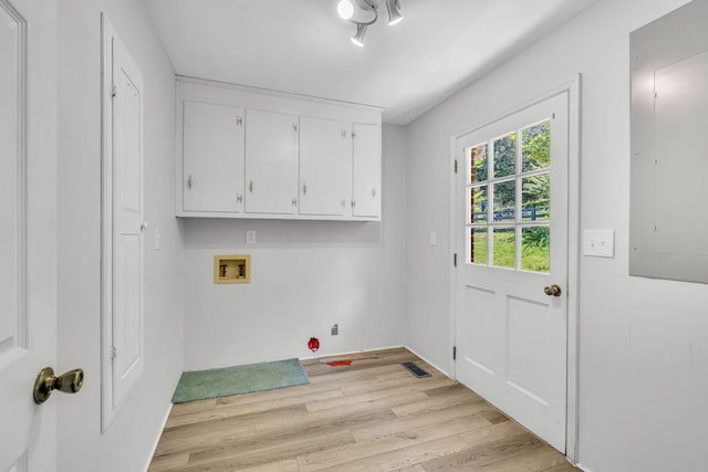 laundry room with cabinets, washer hookup, electric panel, and light hardwood / wood-style floors