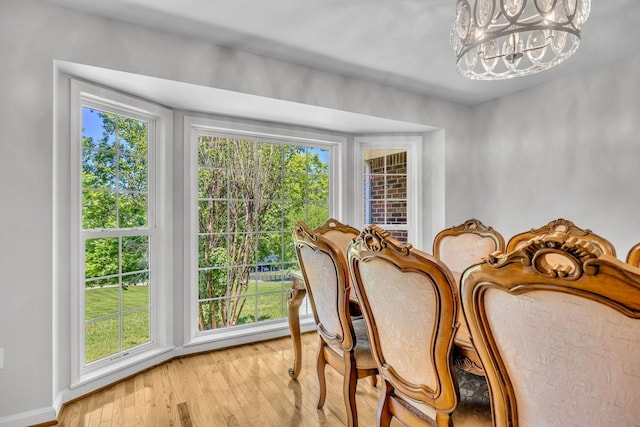 dining space featuring light hardwood / wood-style floors and a chandelier