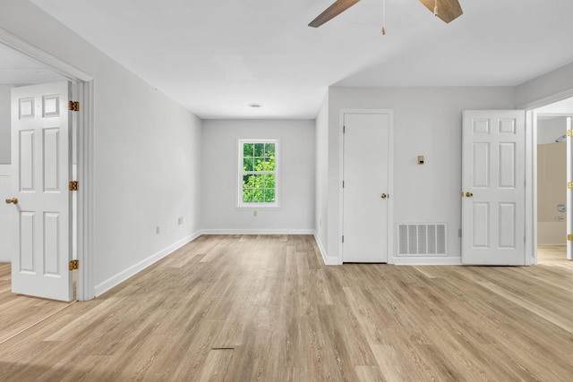 spare room featuring light hardwood / wood-style floors and ceiling fan