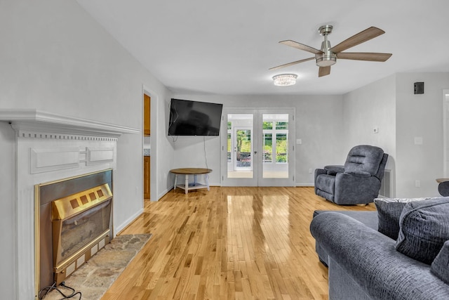 living room featuring light hardwood / wood-style flooring and ceiling fan