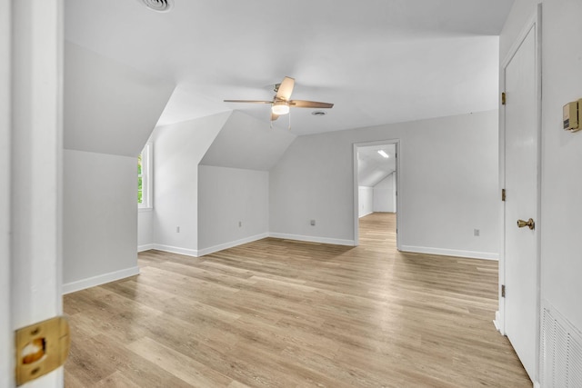 additional living space featuring ceiling fan, light hardwood / wood-style flooring, and vaulted ceiling