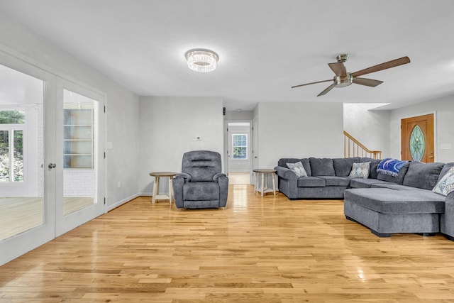 living room with ceiling fan, light hardwood / wood-style flooring, and french doors