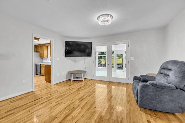 living room featuring light wood-type flooring and french doors