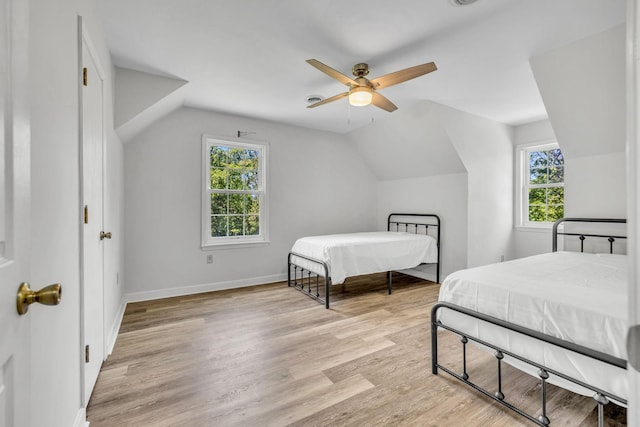 bedroom featuring ceiling fan, vaulted ceiling, and light hardwood / wood-style flooring