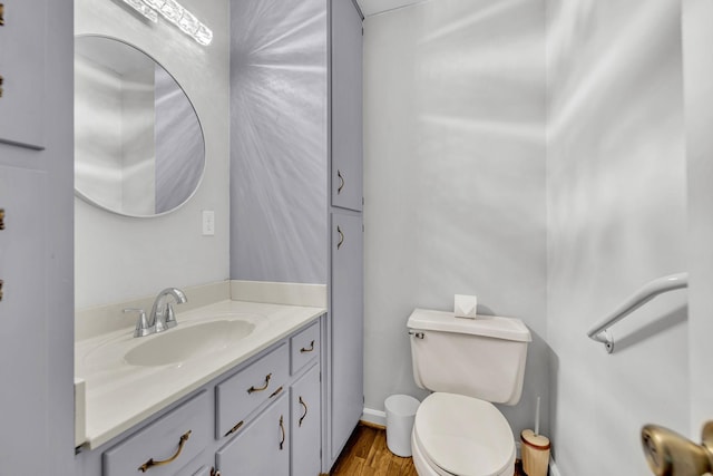 bathroom featuring hardwood / wood-style floors, vanity, and toilet