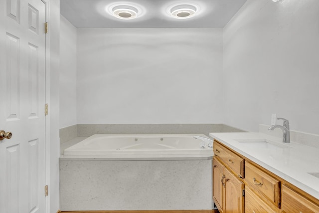 bathroom with vanity and a bath