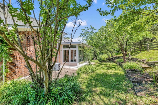 view of yard featuring a sunroom