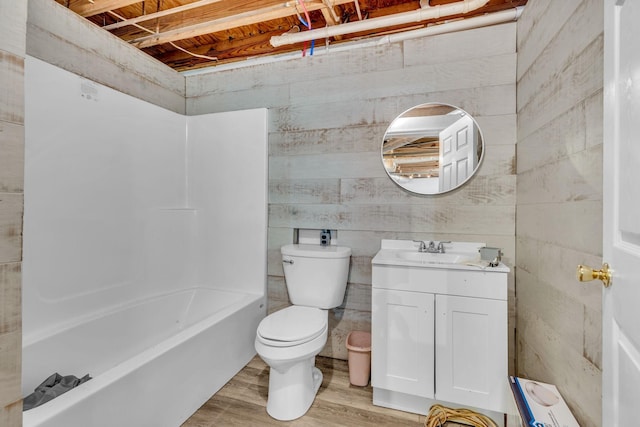 bathroom with wood-type flooring, vanity, toilet, and wooden walls