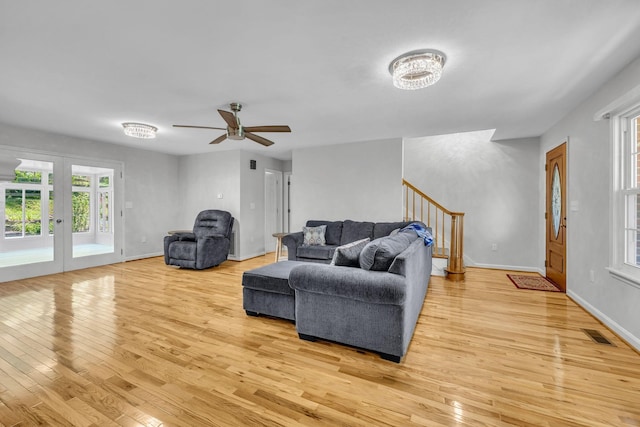 living room with ceiling fan, french doors, and light hardwood / wood-style flooring