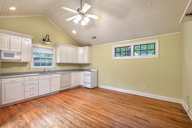 kitchen featuring white cabinetry, sink, light hardwood / wood-style flooring, vaulted ceiling, and white appliances